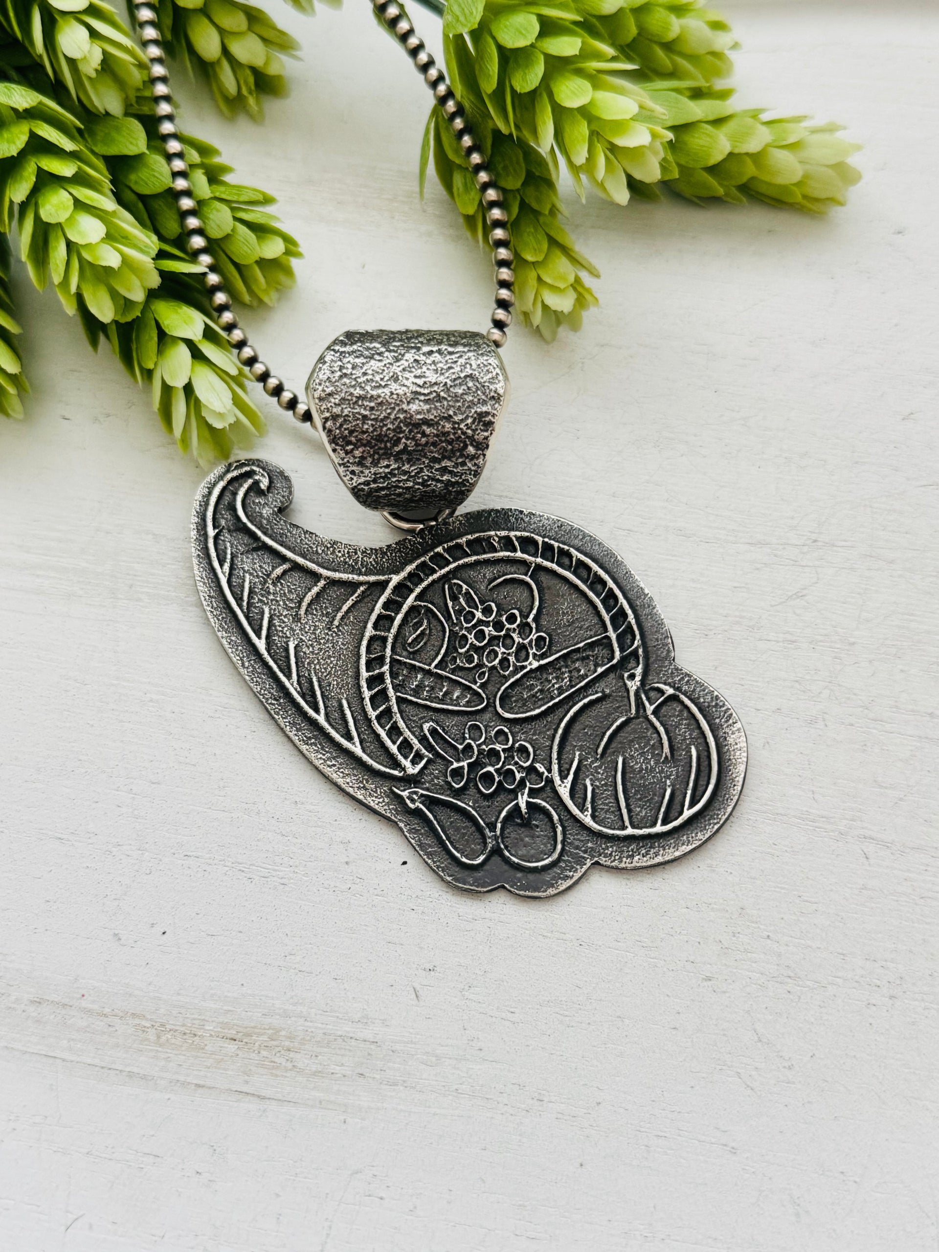 Stanford Yazzie Sterling Silver Tufa Cast Feast Basket Pendant