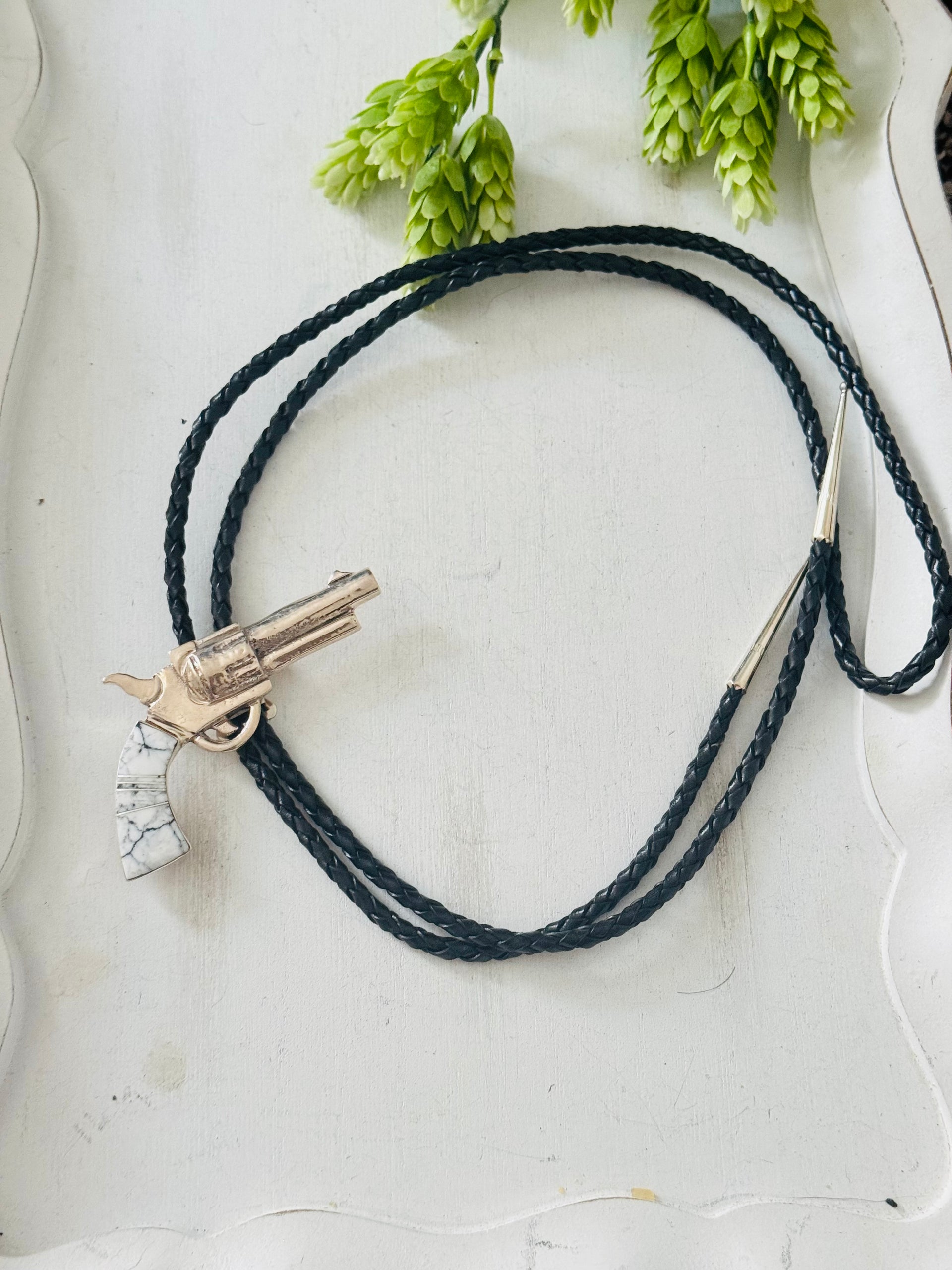 Bobby Mannelito White Buffalo & Sterling Silver Pistol Inlay Bolo Tie