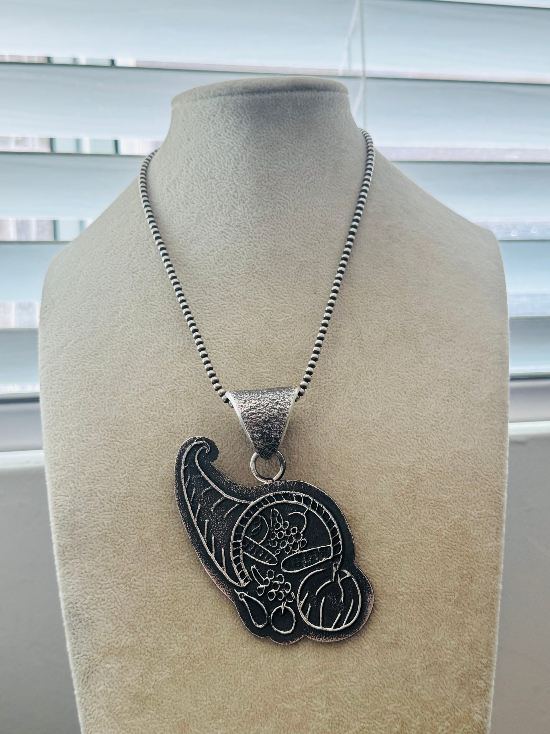 Stanford Yazzie Sterling Silver Tufa Cast Feast Basket Pendant