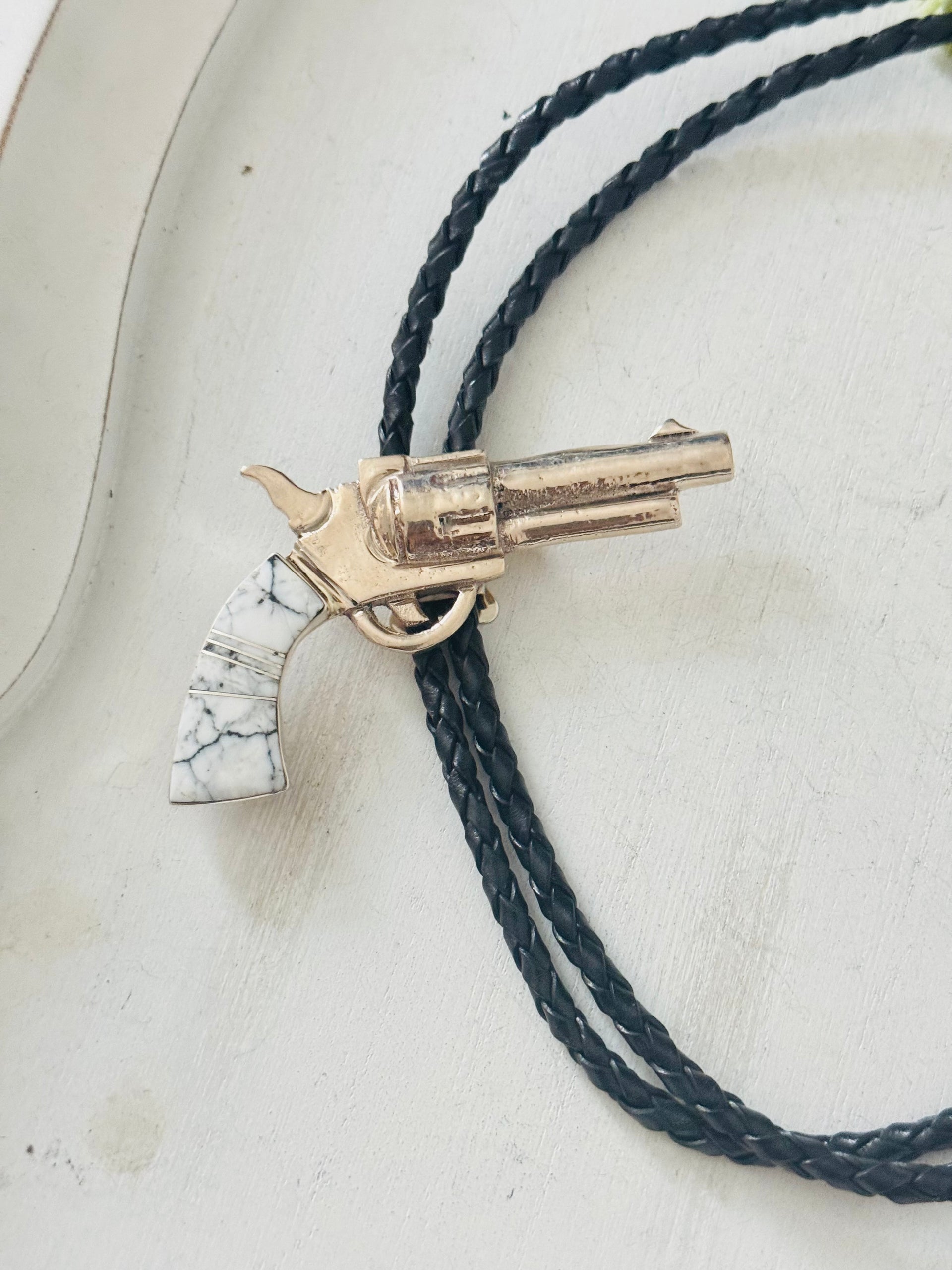 Bobby Mannelito White Buffalo & Sterling Silver Pistol Inlay Bolo Tie